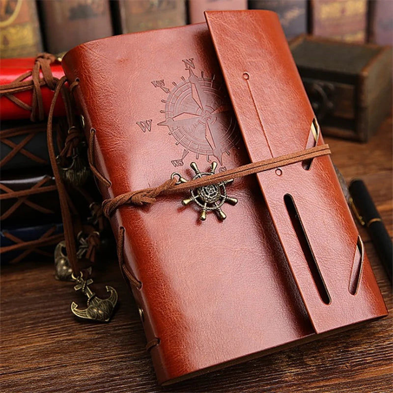 Compact leather-bound traveler's journal with replaceable kraft paper notebooks